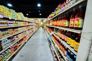 ShuangHurStore-20 Shuang Hur Supermarket aisle with shelves stocked with glass bottles of sauces on the right and canned goods and condiments on the left/